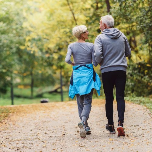 cheerful active senior couple jogging in the park. exercise toge